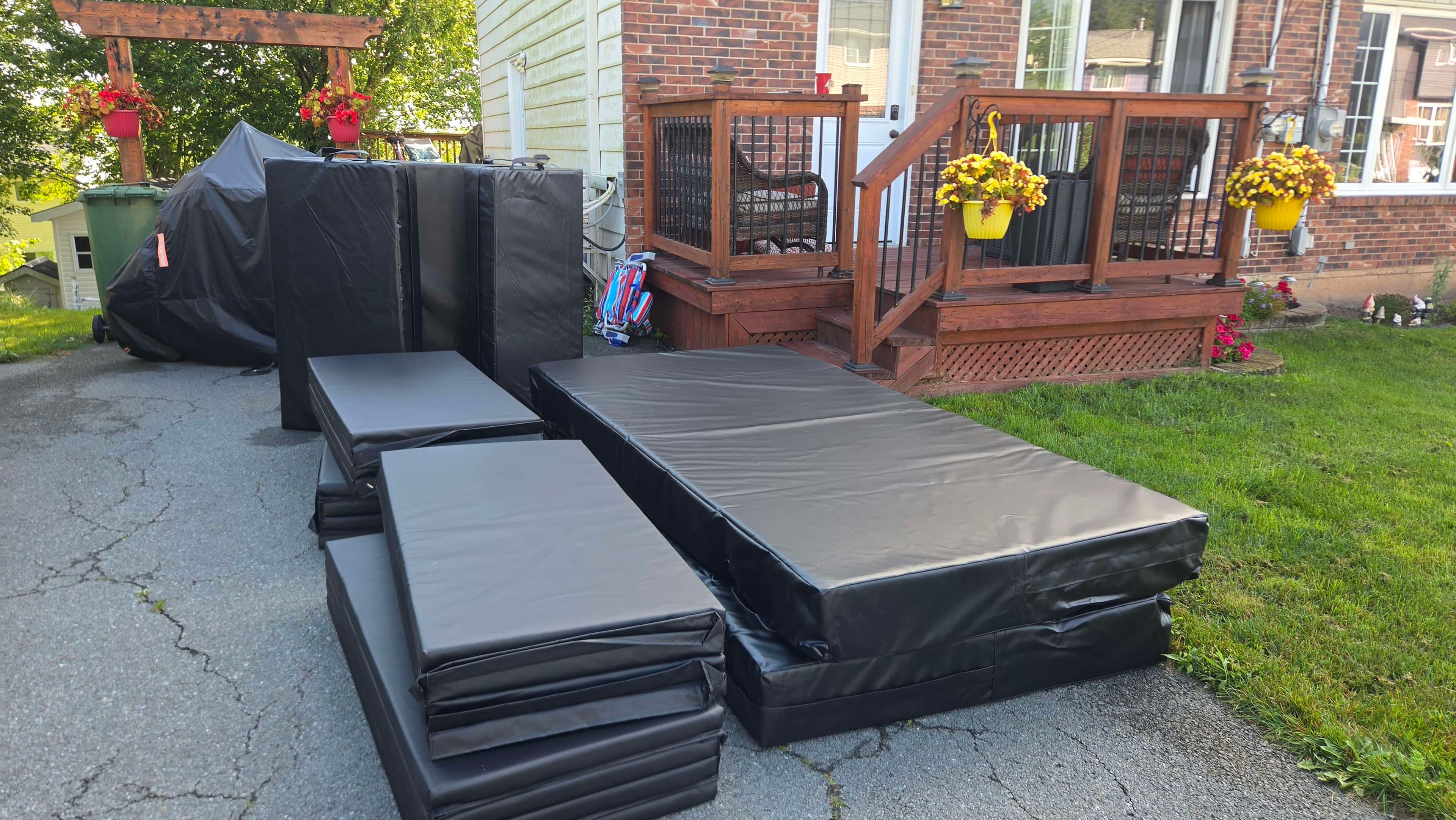 Stunt pads and crash mats stacked and staged for delivery to a film set